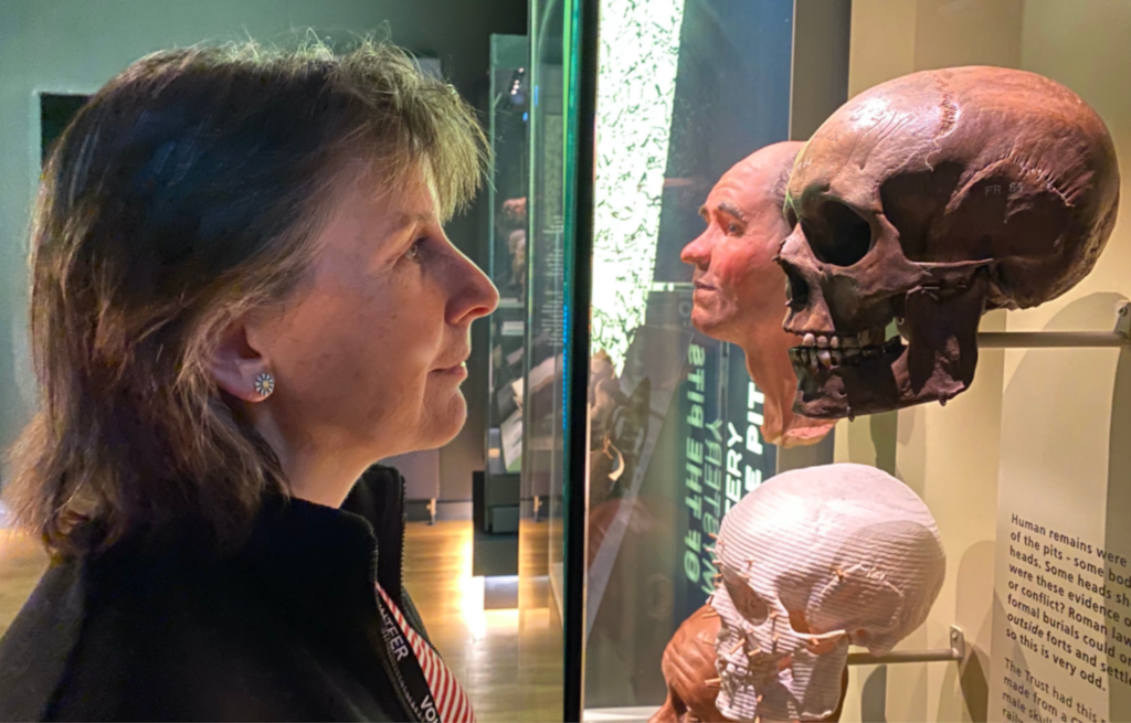 A person looking at a display of facial reconstructions